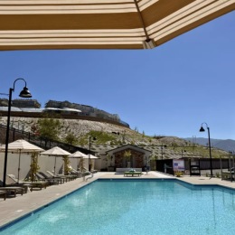Resort-style swimming pool with lounge seating